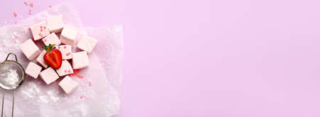 Tasty strawberry marshmallow on color background with space for text