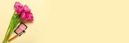 Bouquet of beautiful tulips and decorative cosmetics on light background with space for textの写真素材