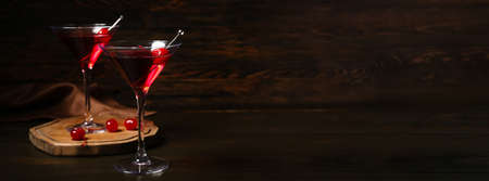 Glasses of delicious Manhattan cocktail on dark background with space for textの写真素材