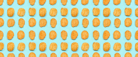 Many tasty potato chips on light blue background. texture for designの写真素材