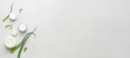 Cosmetic creams with aloe vera extract on light background with space for textの写真素材