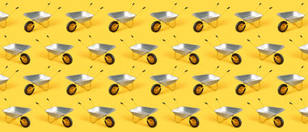 Empty wheelbarrows on yellow backgroundの写真素材
