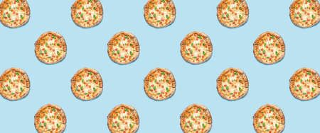 Many sliced pizzas on light blue background. pattern for design