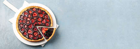 Tasty chocolate strawberry cake on gray background with space for text