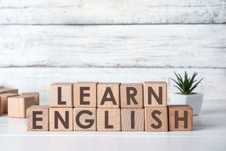 Text LEARN ENGLISH made of cubes on light tableの写真素材