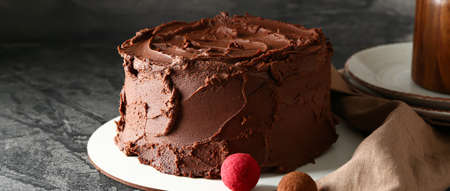 Tasty chocolate cake on dark background