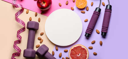Blank card, sports equipment, measuring tape and food on color background. weight loss concept