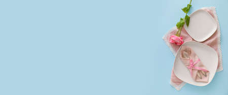Stylish table setting on light blue background with space for text