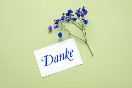 Card with word DANKE (German for Thanks) and flowers on green backgroundの写真素材