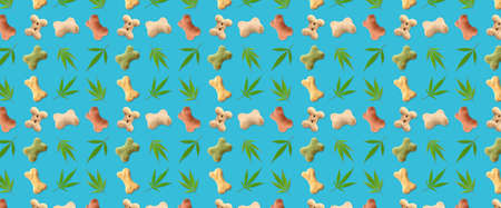 Dry pet food with hemp leaves on blue background