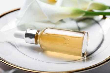 Plate with bottle of essential oil, closeupの写真素材