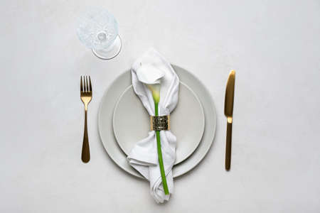 Beautiful table setting with calla lily on light background