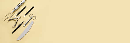 Manicure instruments on beige background with space for text