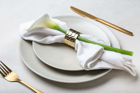 Beautiful table setting with calla lily on light background, closeupの写真素材