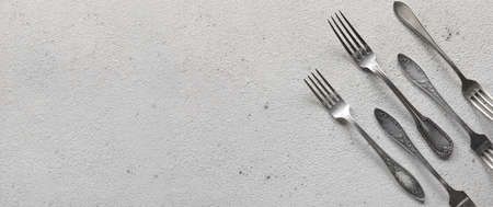 Silver forks on light background with space for textの写真素材