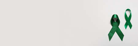 Green ribbons on light background with space for text. Liver cancer conceptの写真素材