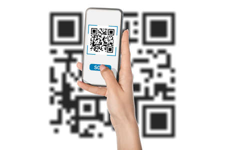 Hand of woman with smartphone scanning QR code on white background