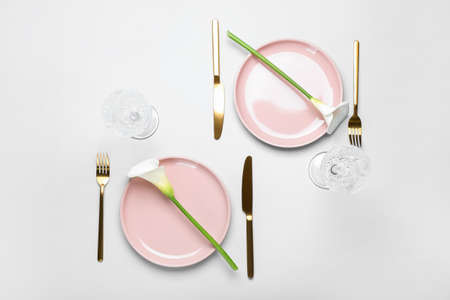 Beautiful table setting with calla lilies on white background