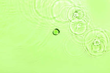 Clean water splashes on color backgroundの写真素材