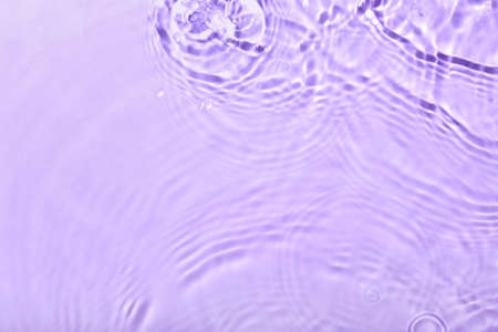 Clean water splashes on color backgroundの写真素材
