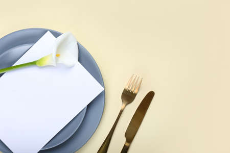 Elegant table setting with calla lily and blank card on color background, closeupの写真素材