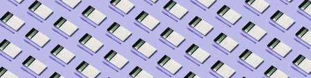 Many calculators and pens on lilac background. pattern for design