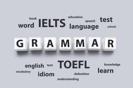 Text GRAMMAR made of cubes and different words on gray background. Concept of studying English