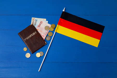 Flag of Germany, passport and money on blue wooden backgroundの写真素材