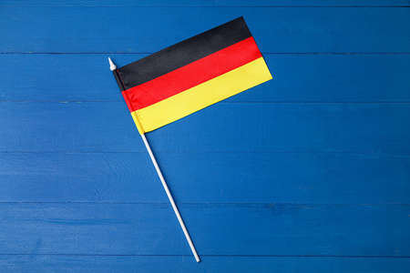 Flag of Germany on blue wooden background