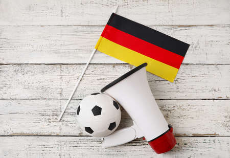 Flag of Germany, bullhorn and soccer ball on light wooden backgroundの写真素材