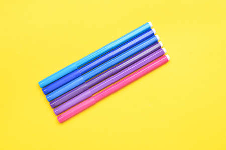 Felt tip pens on yellow background
