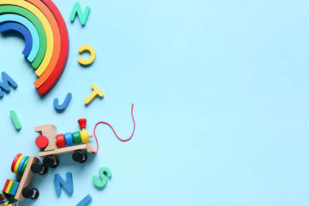 Toy train with building blocks and letters on blue backgroundの写真素材