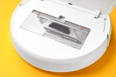 Open robot vacuum cleaner on color background, closeupの写真素材