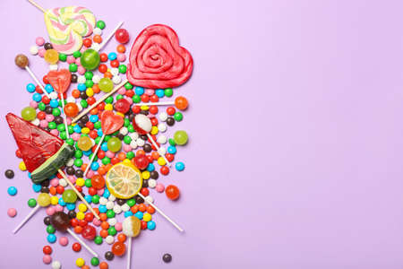 Many sweet candies on lilac backgroundの写真素材