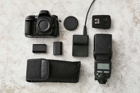 Photo equipment on light table background, top view