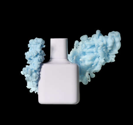 Perfume bottle in blue smoke on black backgroundの写真素材