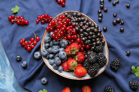 Composition with different ripe berries on color backgroundの写真素材