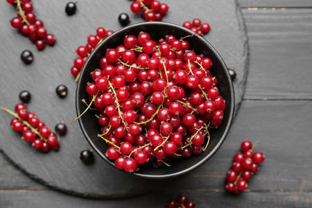 Composition with ripe red currant on dark wooden background, closeupの写真素材