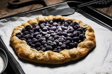 Baking tray with tasty blueberry galette on table, closeupの写真素材