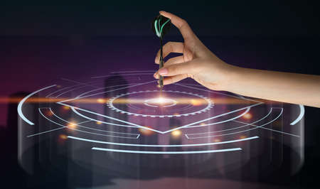 Hand of woman playing virtual darts on dark backgroundの写真素材