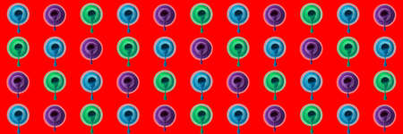 Many bottles of nail polishes on red background. pattern for design