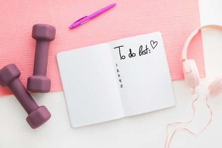 Notebook with blank to-do list and sports equipment on light backgroundの写真素材