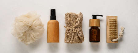 Set of bath accessories and cosmetics on light background, top view