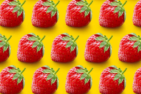 Many sweet ripe strawberries on yellow background. pattern for design
