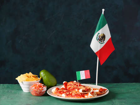 Composition with Mexican traditional food and flags on green backgroundの写真素材