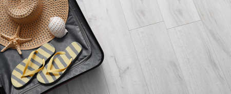Packed suitcase on wooden background,with space for text. travel concept