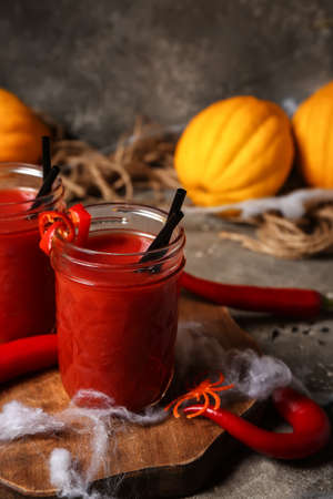 Glasses of tasty bloody Mary cocktail decorated for Halloween on tableの写真素材