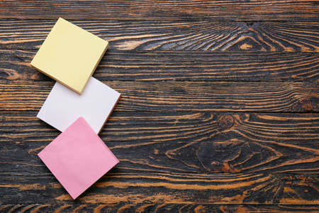 Blank sticky notes on wooden background