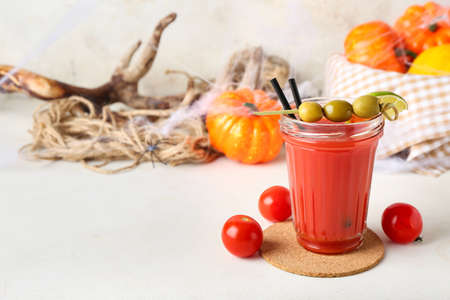 Glass of tasty bloody Mary cocktail on light backgroundの写真素材