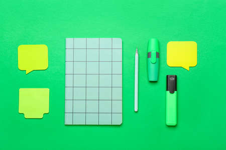 Different blank sticky notes, notebook, pen and markers on color backgroundの写真素材